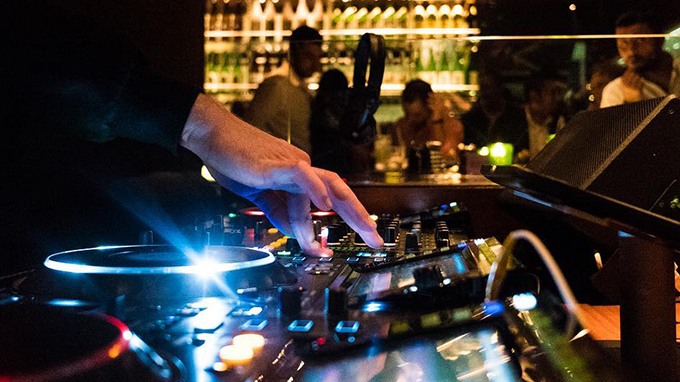 DJ spinning tracks inside restaurant